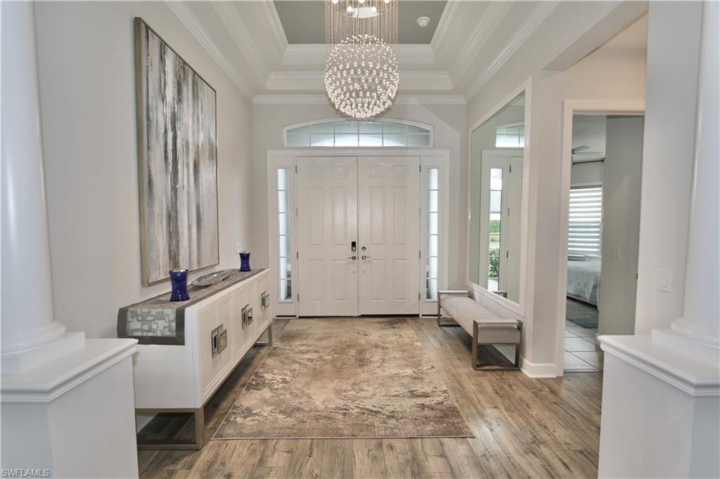 8337 Promoso Court Naples, FL 34114 - Photo 9 of 48 a view of a hallway with windows