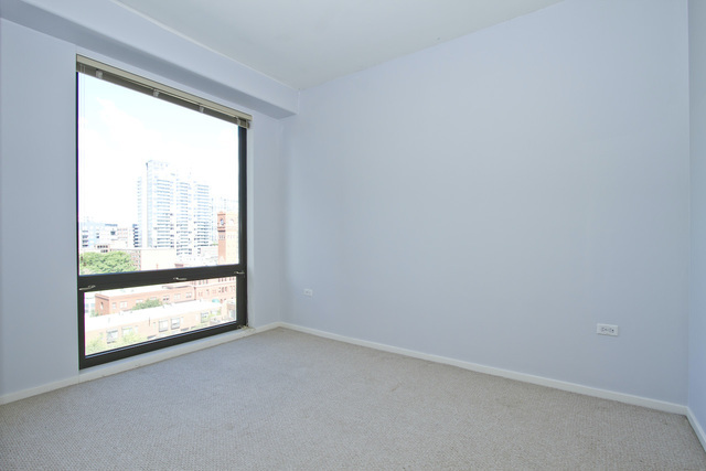 1 East 8th Street, Unit 802 Chicago, IL 60605 - Photo 6 of 12 an empty room with a window