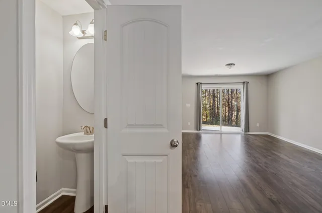 an empty room with wooden floor and a window