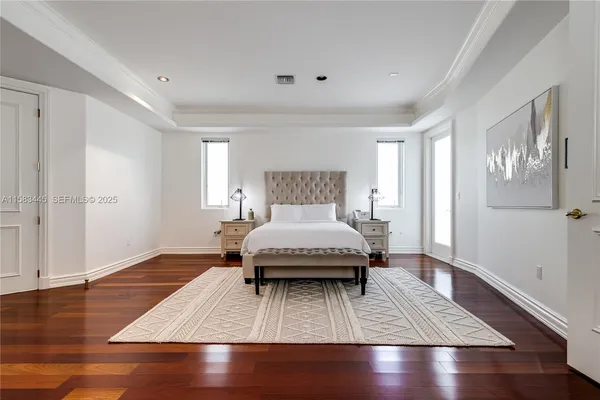 a bedroom with furniture and a flat screen tv