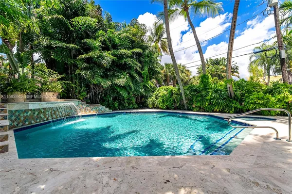 a bathroom with a tub sink shower and mirror