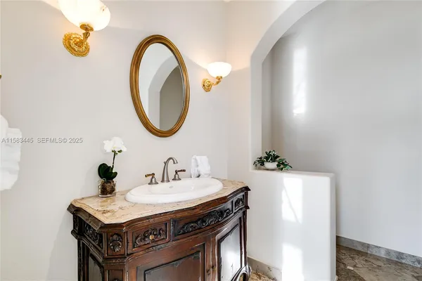 a spacious bathroom with a shower sink and mirror