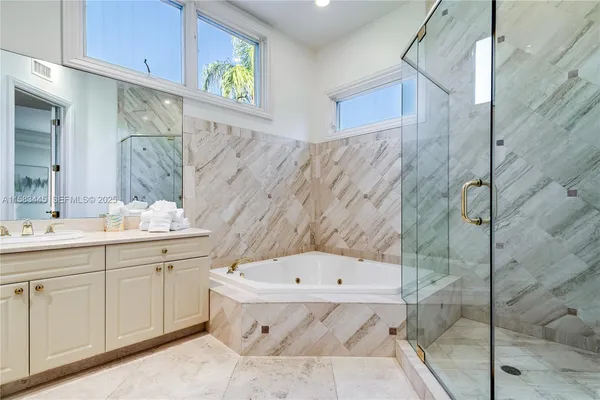 a bathroom with bathtub and shower