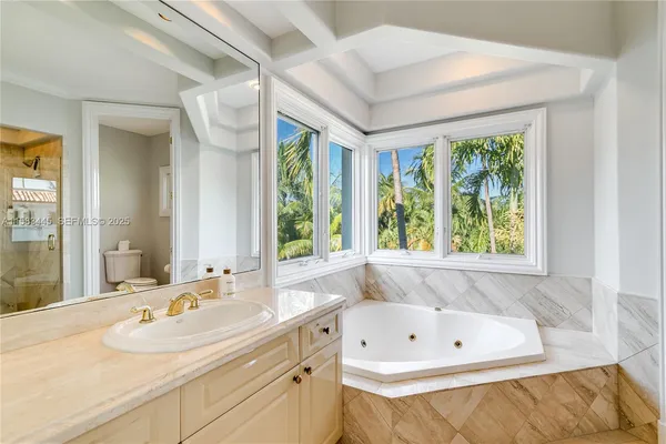 a kitchen with a center island wooden floor and a large window