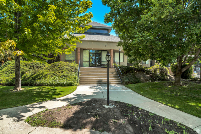 3221 North Shadowbrook Circle Provo, UT 84604 - Photo 23 of 29 Contemporary building exterior featuring a tiered roofline, upper-level clerestory windows, and a central entrance with glass doors