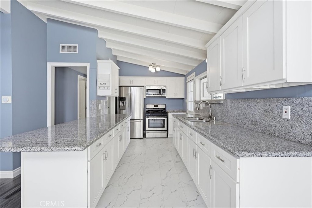 533 South Devon Road Orange, CA 92868 - Photo 5 of 50 a large kitchen with kitchen island granite countertop a large counter top and stainless steel appliances