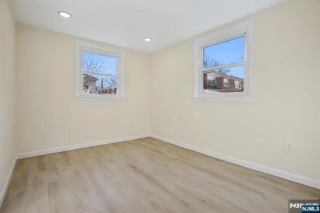 an empty room with a painting on the wall