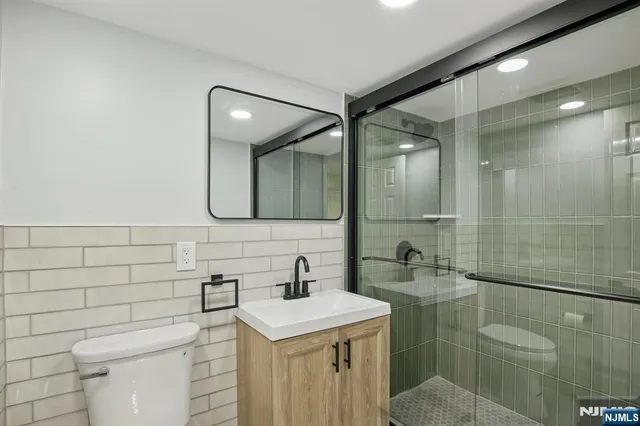a bathroom with a sink toilet and shower