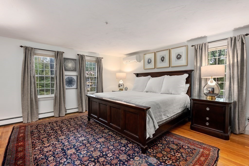 6 Highland Road Acton, MA 01720 - Photo 17 of 35 a bedroom with a bed and wooden floor