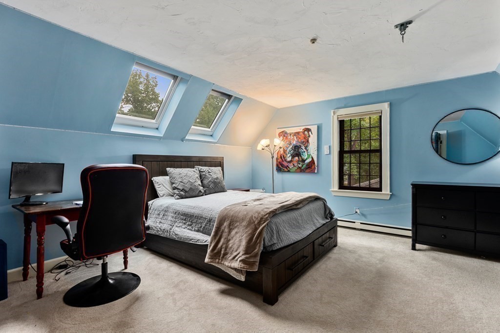 6 Highland Road Acton, MA 01720 - Photo 24 of 35 a spacious bedroom with a bed and a chandelier