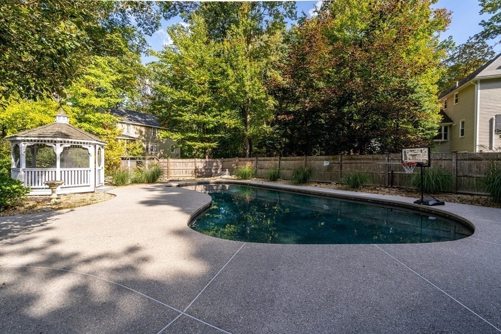 6 Highland Road Acton, MA 01720 - Photo 27 of 35 a view of a patio with a table and chairs under an umbrella