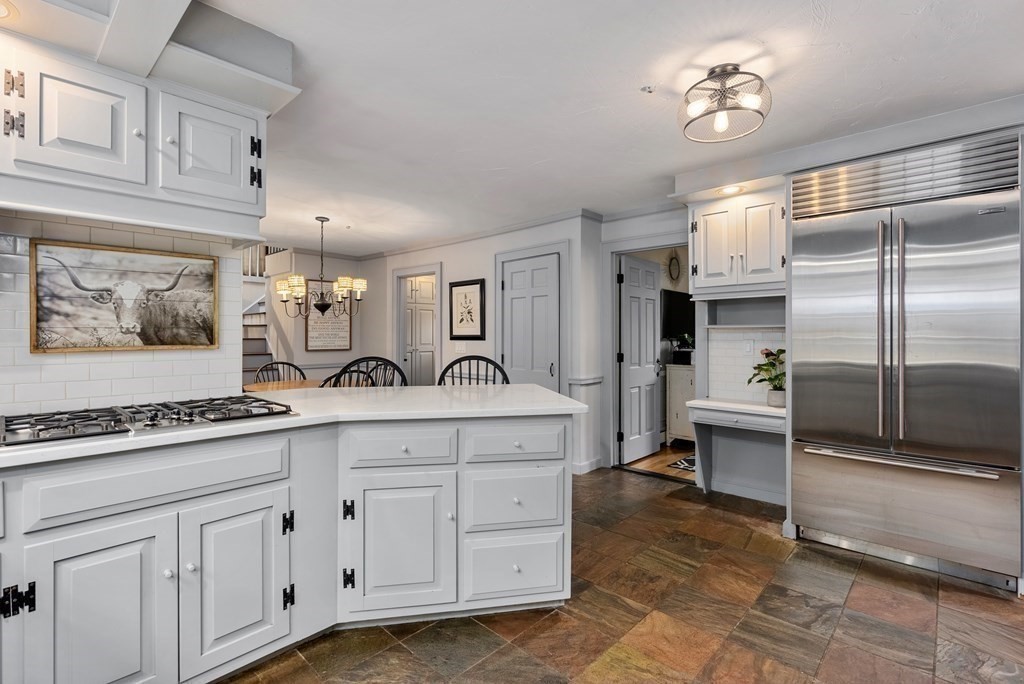 6 Highland Road Acton, MA 01720 - Photo 8 of 35 a view of a kitchen with cabinets stainless steel appliances and a chandelier