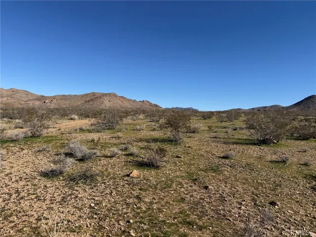 a view of a large mountain with mountains in the background