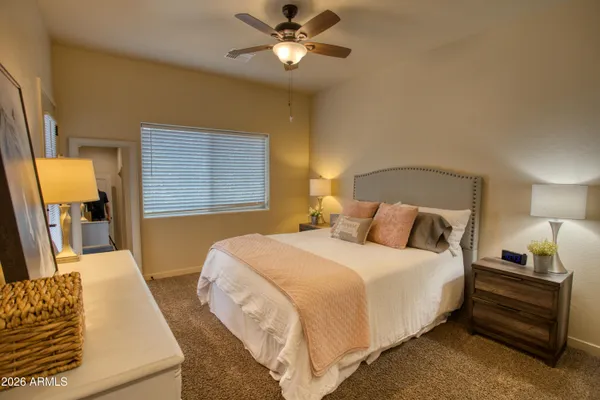 a bedroom with a bed and a chandelier