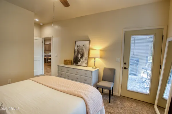 a bedroom with a bed and a chair