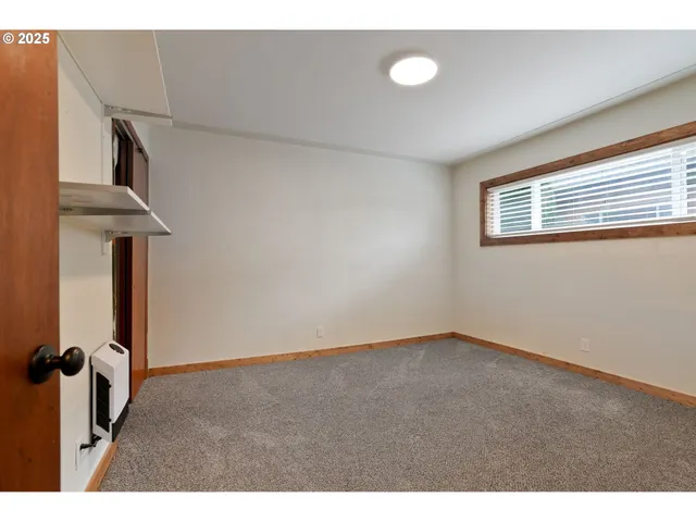 a view of hallway with stairs and wooden floor