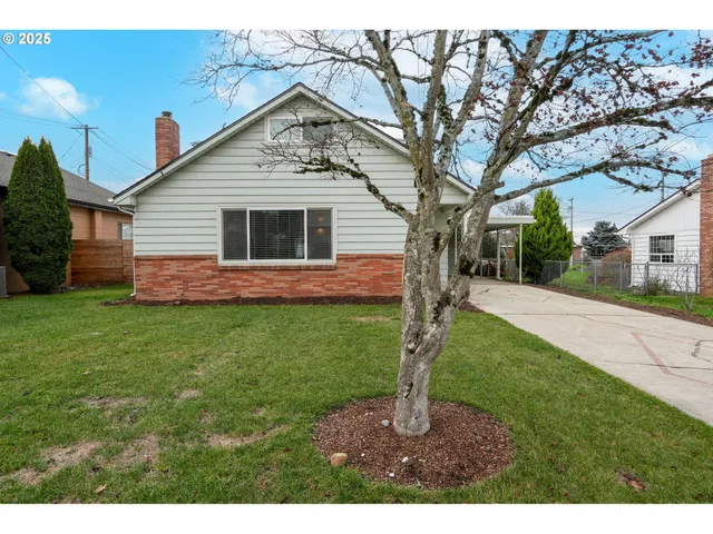 a front view of house with backyard and green space
