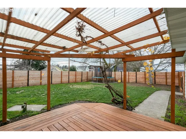 a backyard of a house with table and chairs