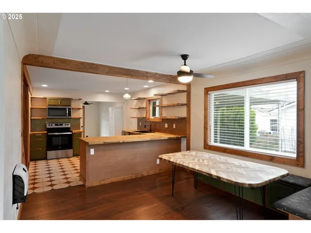 a living room with kitchen island furniture and a kitchen view