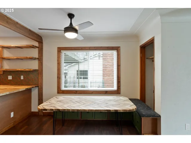 a view of room with kitchen island a sink dishwasher and wooden cabinets