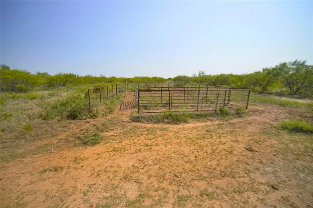 a view of a lush green hillside and a building