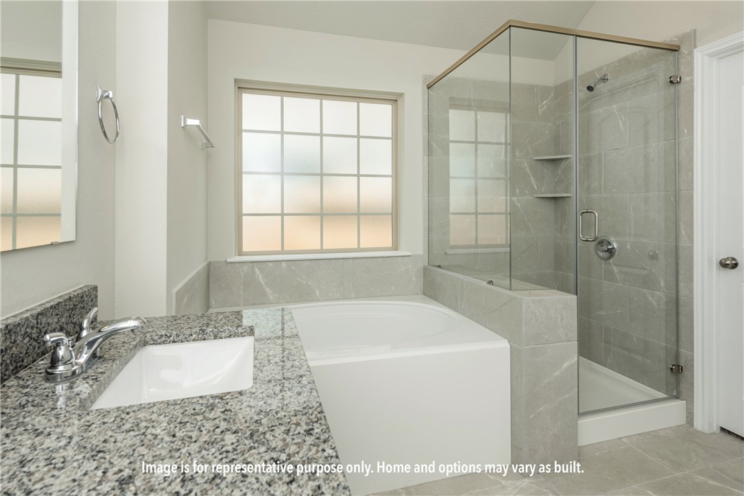 1913 Meridian Court Bryan, TX 77807 - Photo 10 of 15 a bathroom with a granite countertop tub a sink and a shower