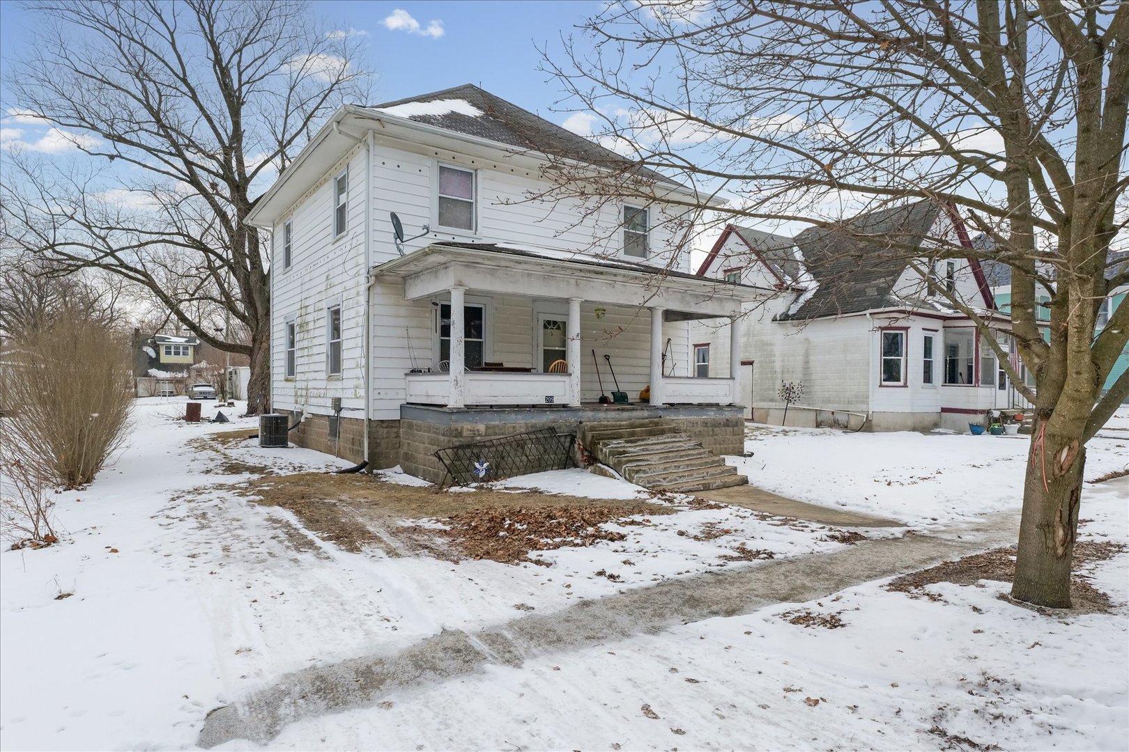 209 North Green Street Melvin, IL 60952 - Photo 3 of 24 a front view of a house with a yard covered in snow