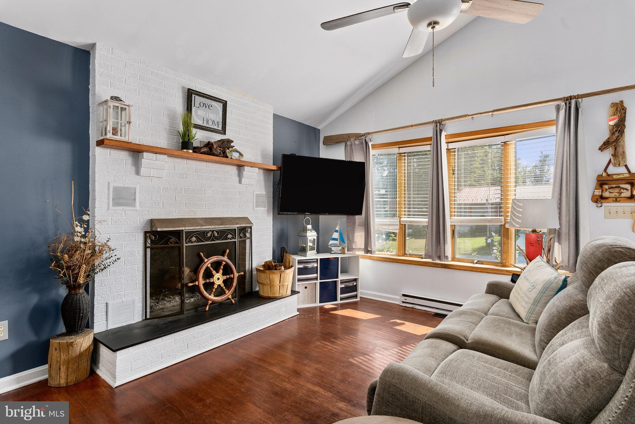 33 Low Road Earleville, MD 21919 - Photo 6 of 35 a living room with furniture a flat screen tv and a fireplace