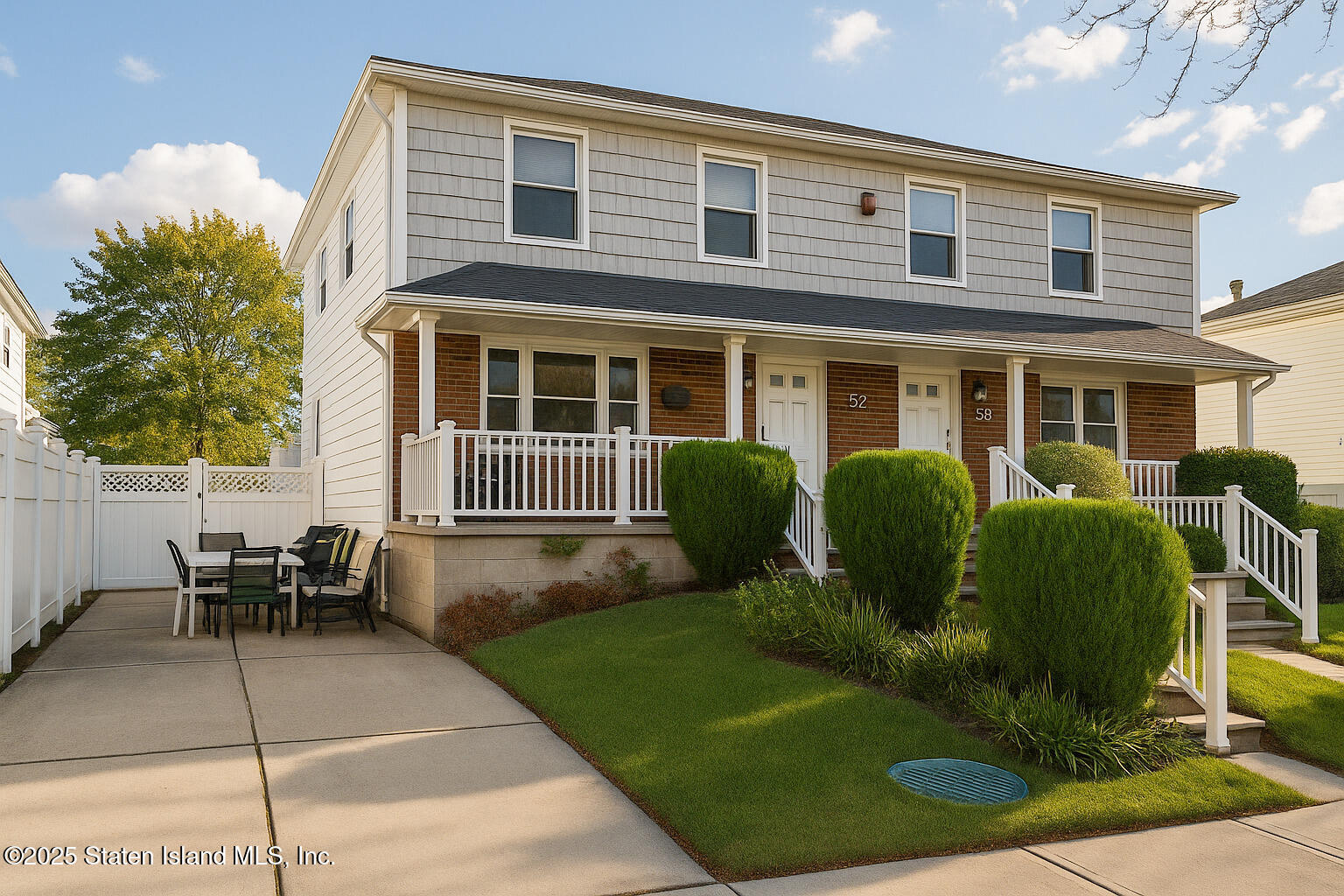 a front view of a house with a garden and sitting area