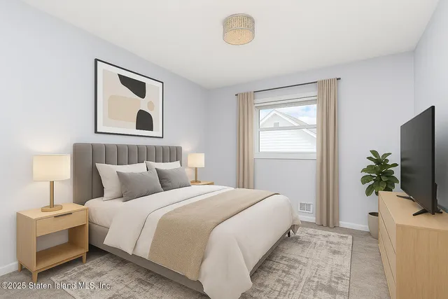 a bedroom with a bed and a flat screen tv