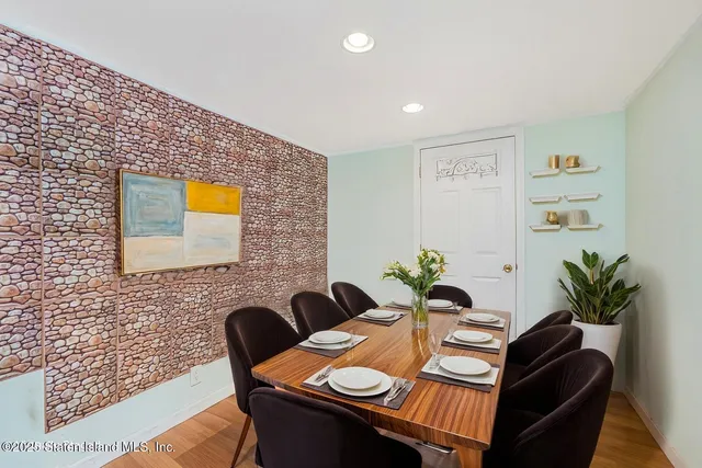 a dining room with furniture and wooden floor