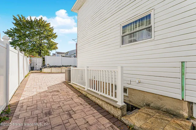 a view of a backyard with a large tree
