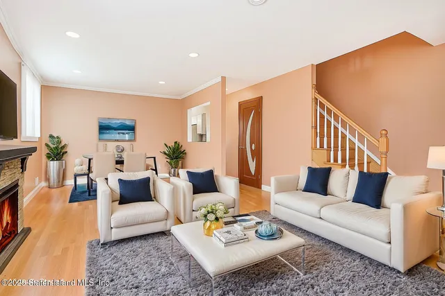 a living room with furniture flat screen tv and a couch