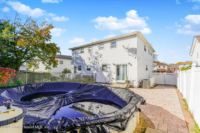 a view of a patio with couches table and chairs and potted plants