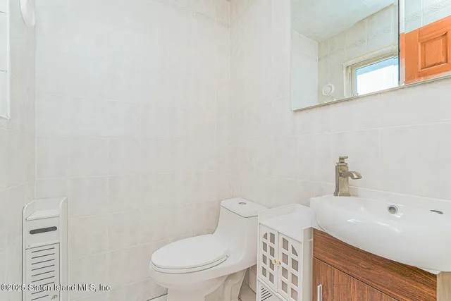 a white toilet sitting next to a bathroom sink