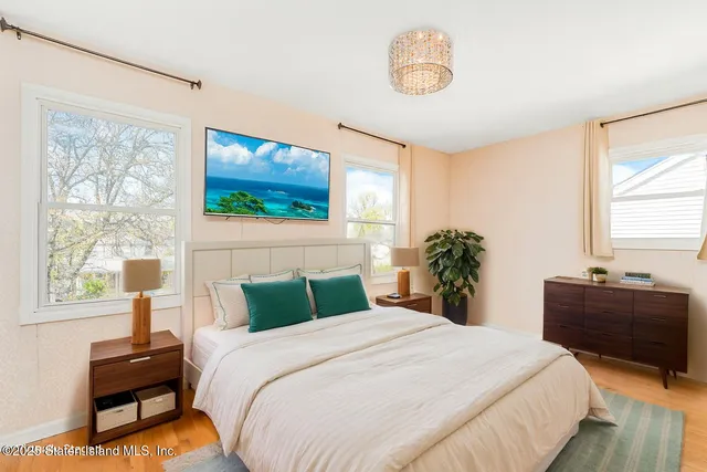 a bedroom with a bed and a flat screen tv