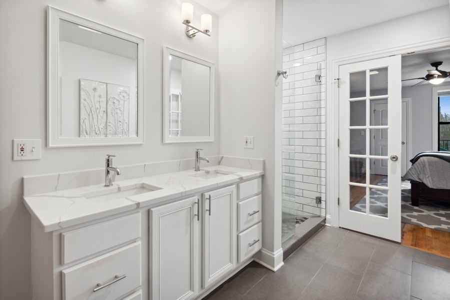 1025 West Madison Street, Unit 4 Chicago, IL 60607 - Photo 14 of 26 a bathroom with a sink double vanity and a mirror