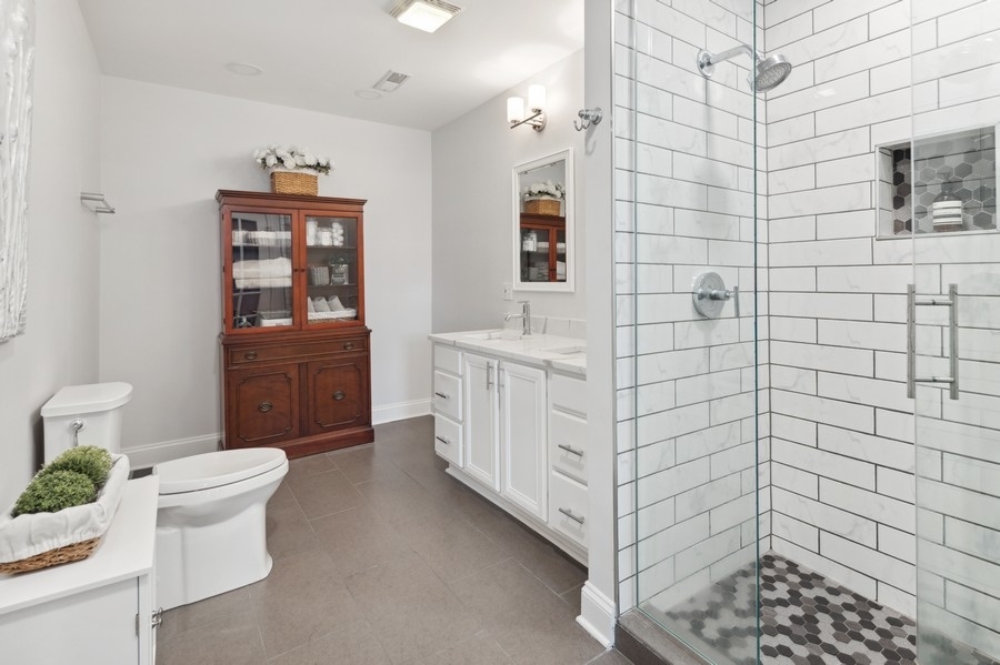 1025 West Madison Street, Unit 4 Chicago, IL 60607 - Photo 15 of 26 a bathroom with a sink a toilet and shower