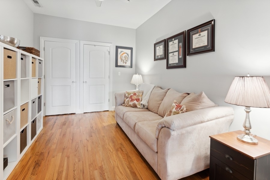1025 West Madison Street, Unit 4 Chicago, IL 60607 - Photo 16 of 26 a living room with furniture and a wooden floor