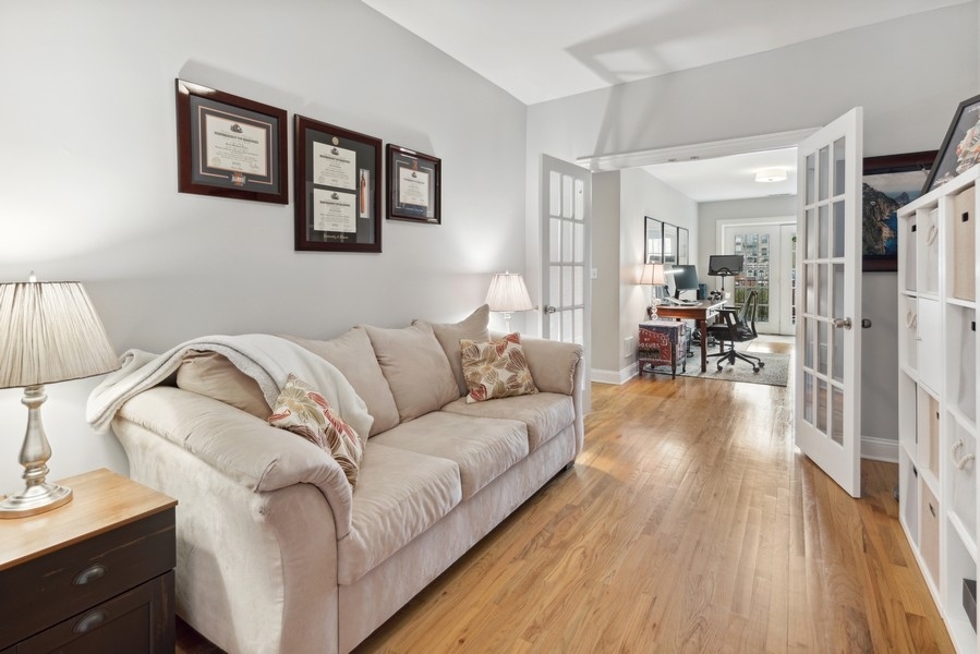 1025 West Madison Street, Unit 4 Chicago, IL 60607 - Photo 17 of 26 a living room with furniture and wooden floor