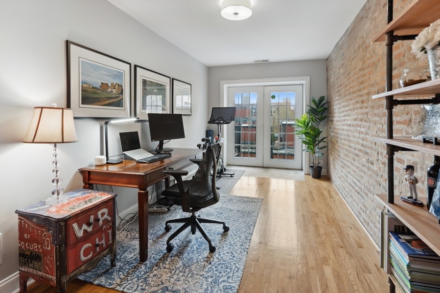 1025 West Madison Street, Unit 4 Chicago, IL 60607 - Photo 18 of 26 a living room with furniture a piano and a bookshelf