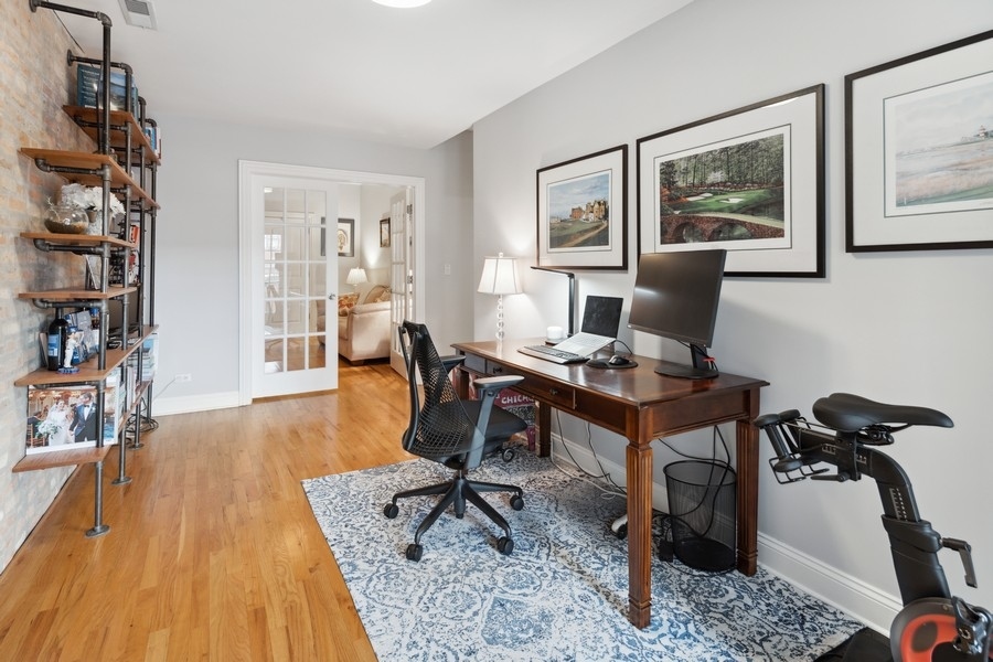 1025 West Madison Street, Unit 4 Chicago, IL 60607 - Photo 19 of 26 a view of a workspace with furniture and wooden floor