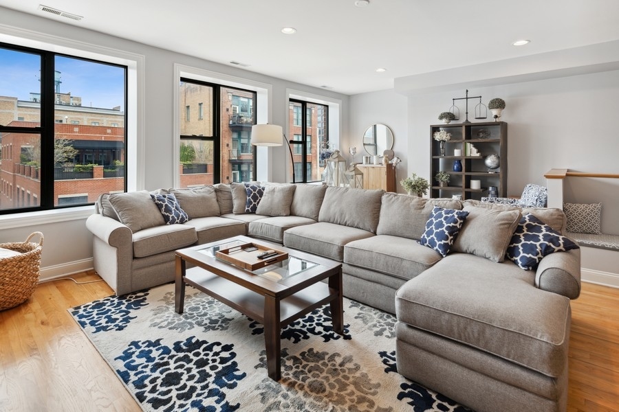 1025 West Madison Street, Unit 4 Chicago, IL 60607 - Photo 2 of 26 a living room with furniture ceiling fan and a window