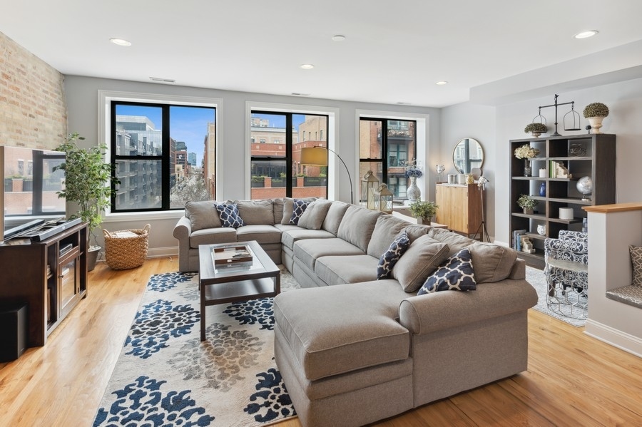 1025 West Madison Street, Unit 4 Chicago, IL 60607 - Photo 3 of 26 a living room with furniture ceiling fan and a rug