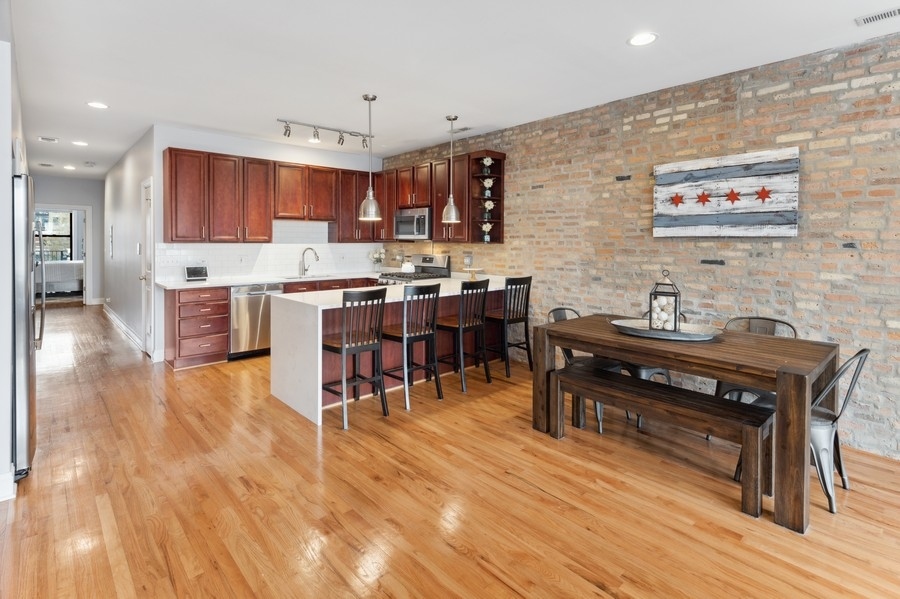 1025 West Madison Street, Unit 4 Chicago, IL 60607 - Photo 10 of 26 a living room with lots of furniture and kitchen view