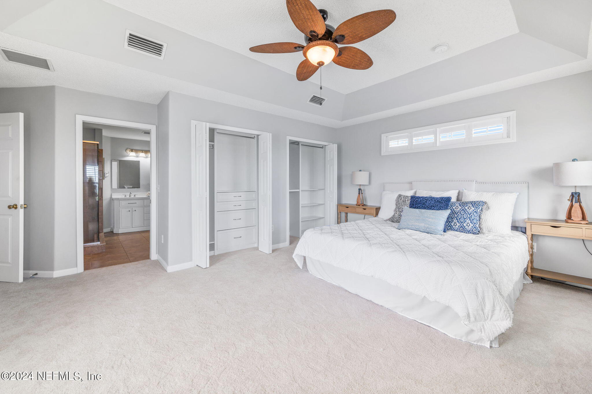136 Beachside Drive Ponte Vedra Beach, FL 32082 - Photo 15 of 23 a spacious bedroom with a bed and a ceiling fan