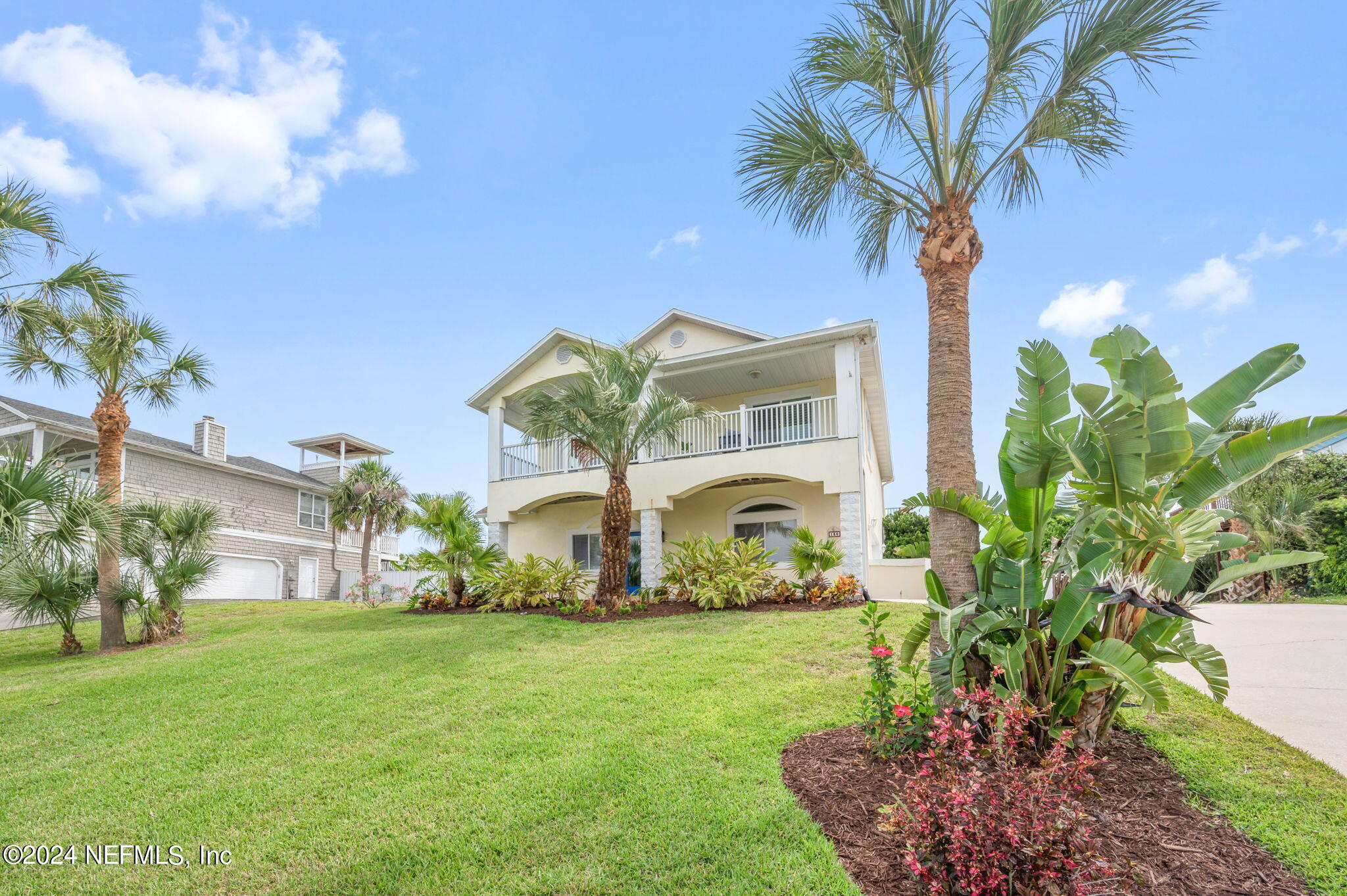 136 Beachside Drive Ponte Vedra Beach, FL 32082 - Photo 2 of 23 a front view of a house with garden