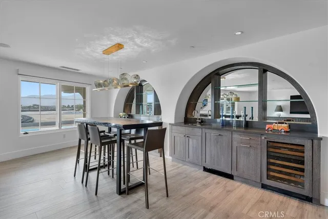 a kitchen with stainless steel appliances a sink stove and wooden floor
