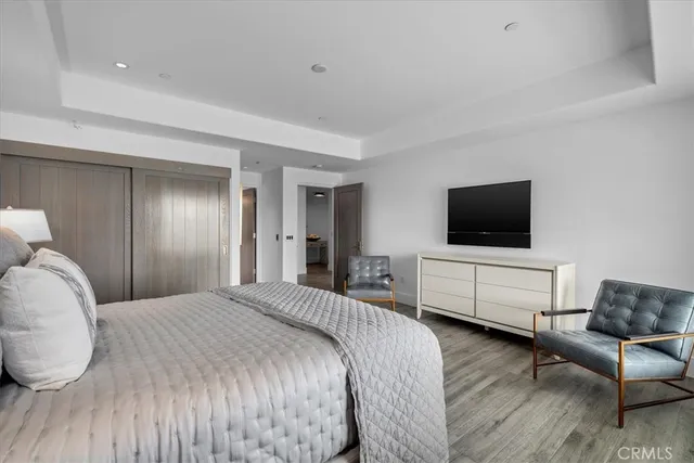 a view of a hallway with wooden floor windows