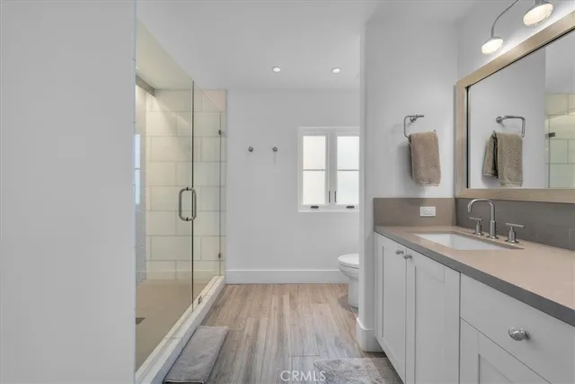 a bedroom with a large bed and a night stand